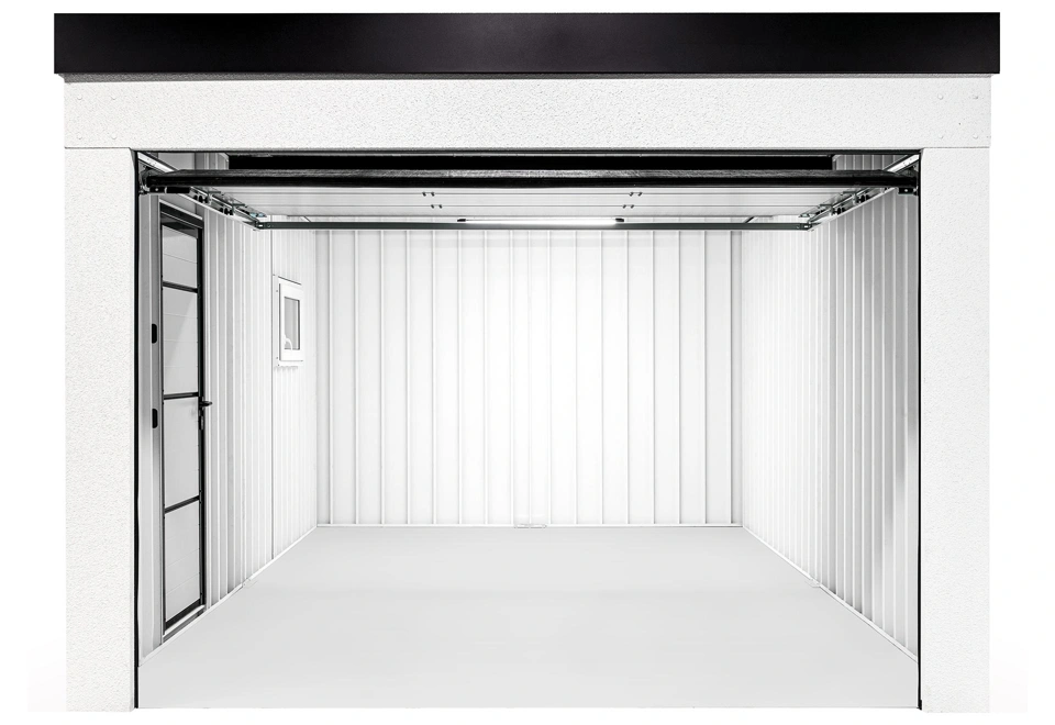 Otevřená montovaná garáž 3,5 x 6 m s oknem, zateplenými dveřmi, bílou omítkou a doplňky v černé barvě, prázdný interiér s bílými stěnami.