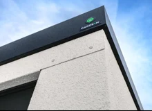 Detail rohu montované garáže, designové bílé omítky a černé atiky.