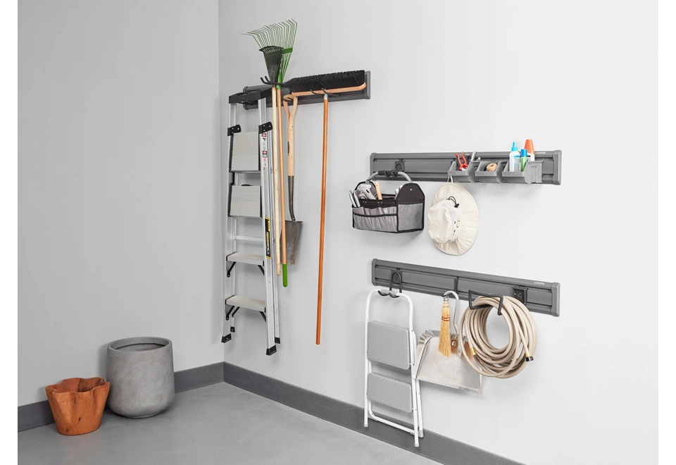 Tři nástěnné nosníky s háčky a boxy na nářadí.